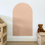Blush pink coloured arch shaped children's magnetic wall decal on a white wall